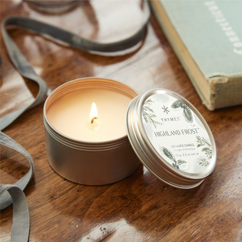 Thymes Highland Frost Travel Tin Candle lit from above image number 2
